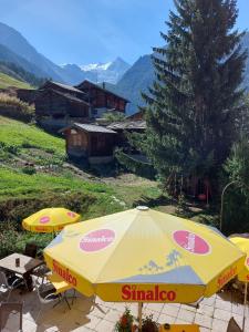 a group of yellow umbrellas sitting on a patio at B&B Alpenrösli in Gasenried