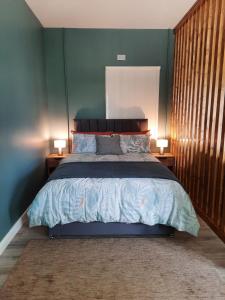 a bedroom with a large bed with two lamps on tables at Studio in Letterkenny