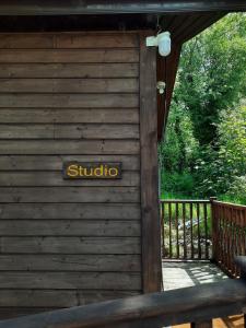 a wooden cabin with a sign on the side of it at Studio in Letterkenny