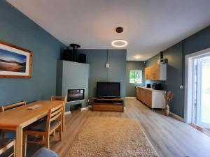 a living room with a table and a television at Studio in Letterkenny