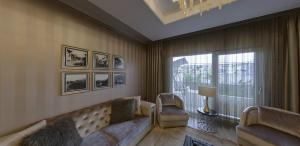 a living room with a couch and a window at SELAM REZİDANCE BUİLDİNG LUXURY APARTMENT in Hamitler
