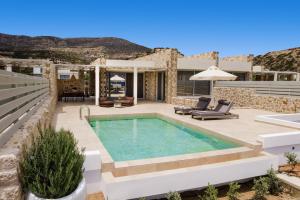 a villa with a swimming pool and a patio at Orelia Luxury Villas in Amoopi