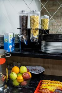 a kitchen counter with bowls of fruit and other food at The Queen Hotel in Istanbul