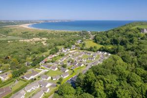 an aerial view of a village next to the ocean at Ty Seren in Oxwich