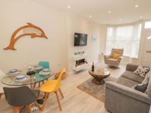 a living room with a couch and a table at Bay View in Criccieth