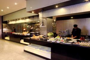 a buffet line with food on display in a restaurant at Tuli Imperial in Nagpur