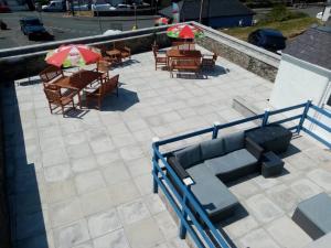 an overhead view of a patio with tables and umbrellas at Anglesey home by the sea in Amlwch