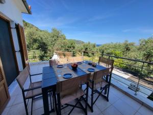 a table and chairs on a balcony with a view at Omikron in Mikro