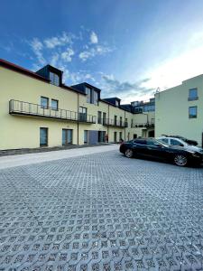 a black car parked in front of a building at Royal Apartments Liptovsky Mikulas in Liptovský Mikuláš