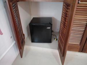 a small television sitting in the corner of a room at Private Apartment in Caribe Dominicus 3 SOLO ADULTOS in La Laguna