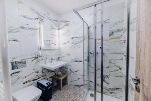 a bathroom with a shower and a sink at Point Pension in Brno