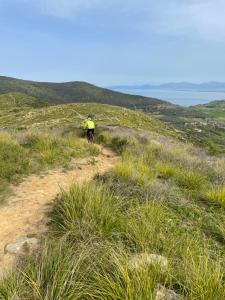 a person riding a bike down a dirt trail on a hill at Tresino Rooms in Agropoli