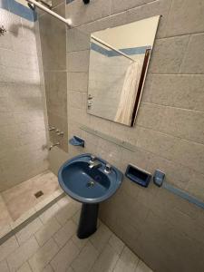 a bathroom with a blue sink and a mirror at POSADA DEL CENTRO in Villa General Belgrano +73 photos
