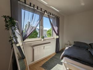 a bedroom with a bed and a large window at Feldberg Appartement in Neu-Anspach