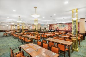 a dining room with wooden tables and chairs at Danubius Hotel Hungaria City Center in Budapest