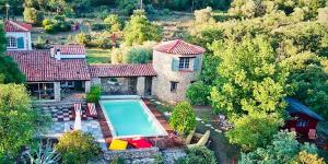 an aerial view of a house with a swimming pool at L’Hacienda Maison d’hôtes in Bagnols-en-Forêt
