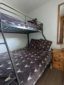 a bedroom with a bunk bed with a bedspread with white horses at Combe Blanche 1217 in Manigod