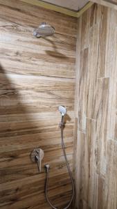 a shower with a hose attached to a wooden wall at XYZ-Osijek in Osijek +29 photos