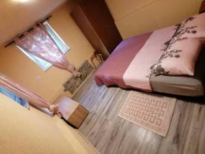 a small bedroom with a bed and a window at Apartment in Veprinac in Veprinac