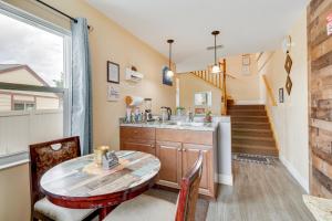 a kitchen with a table and a sink and a staircase at 25 Mi to Disney Home with Shared Pool in Orlando in Orlando