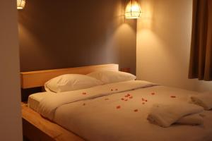 a bedroom with a bed with red flowers on it at Dalya Life in Göcek