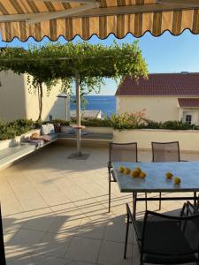 a table with fruit on it on a patio at Apartments Plazibat in Hvar