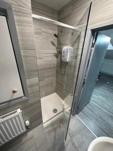 een douche met een glazen deur in de badkamer bij Gulson Estates B&B in Parkside
