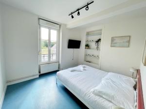 a white bedroom with a bed and a window at Relais Touraine Sologne in Noyers-sur-Cher