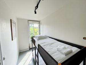 a bedroom with a bed in a room with a window at Relais Touraine Sologne in Noyers-sur-Cher