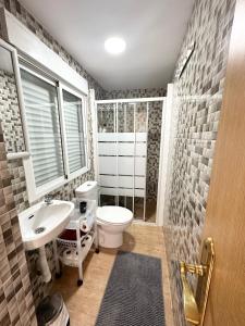 a bathroom with a toilet and a sink at Apartment en Rambla in Alicante