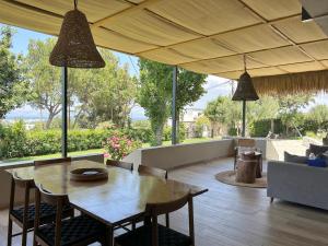 a dining room and living room with a table and chairs at MyKosVilla with private pool in Kos Town