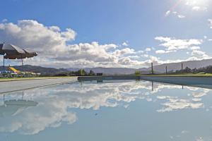 a swimming pool with a reflection of the sky at Campo Seco in Vieira do Minho