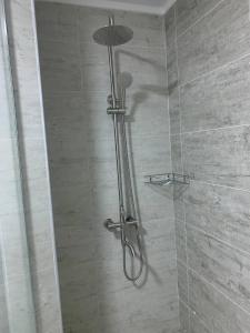 a shower with a shower head in a bathroom at Vzmorie Resort Hotel in Bosteri