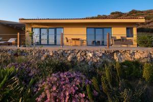 a house with a garden in front of it at Elpida - breathtaking view in Mochlos