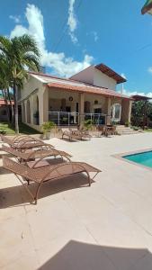 a group of benches in front of a building at Pousada Brisa do Mar in Aquiraz