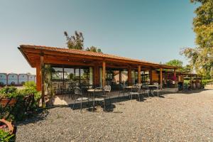a pavilion with chairs and tables in a park at Agriturismo il Laghetto in Grosseto