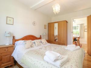a bedroom with a large bed with towels on it at High Stile in Keswick