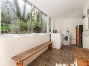 a kitchen with a bench and a window at High Stile in Keswick