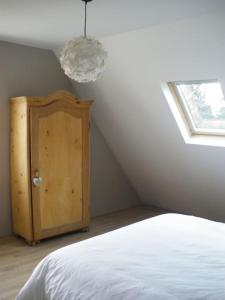 a bedroom with a white bed and a window at Villa de charme Alsace - Riquewihr in Riquewihr