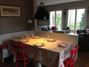 a dining room table with a table cloth with wine glasses at Villa de charme Alsace - Riquewihr in Riquewihr