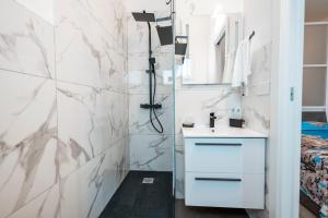 a white bathroom with a sink and a shower at LA MANDORLA Luxury Rooms in Caltabellotta +33 photos