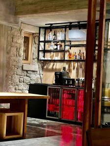 a bar with a table and a counter with drinks at Warszawski Alaçatı in Alaçatı