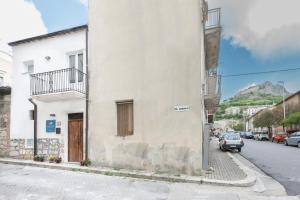 a white building on the side of a street at LA MANDORLA Luxury Rooms in Caltabellotta