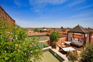 a backyard with a swimming pool and a gazebo at Riad du Ciel Marrakech in Marrakesh