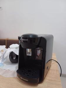 a coffee maker sitting on top of a table at Cabana Acasă la Delia in Gîrda de Sus