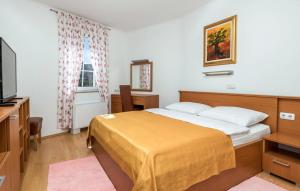 a hotel room with a bed and a television at Villa Superior in Rab +27 photos