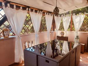 a room with large windows with white curtains at Appartamenti via Lombardo in Giardini Naxos