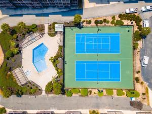 an overhead view of a tennis court with two tennis courts at Sweet Caroline Remodeled with Partial Ocean View and Oceanfront Pool in Myrtle Beach