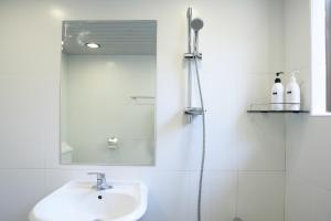 a bathroom with a sink and a mirror at Mido Hostel in Seogwipo