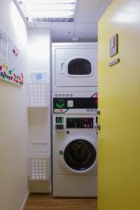 a washer and dryer in a laundry room at Green World Hotel - Zhonghua in Taipei